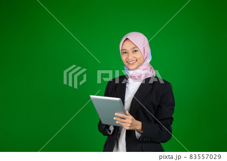 Muslim girl in hijab using a digital tablet with copyspace Muslim girl in hijab using a digital tablet with copyspace 83557029