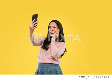 beautiful woman hand on cheek while selfie with camera smartphone 83557184