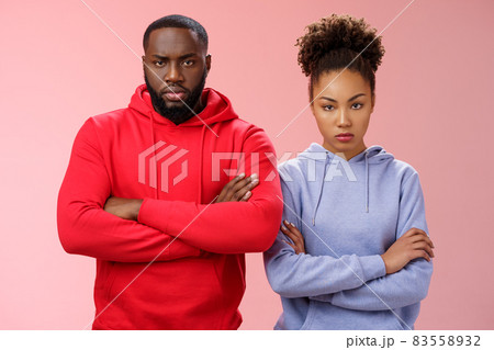 Two attractive african friends coworkers serious-looking standing confident strong pose arms crossed chest look determined focused camera wanna beat rival team computer game, self-assured Two attractive african friends coworkers serious-looking standing confident strong pose arms crossed chest look determined focused camera wanna beat rival team computer game, self-assured 83558932