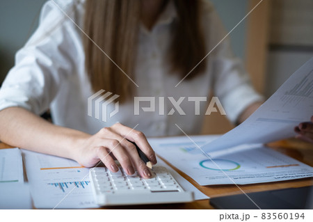 Close up Hand of Business woman working to analyze technical price graph and indicator. Close up Hand of Business woman working to analyze technical price graph and indicator. 83560194