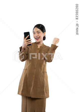 Excited female teacher in civil servant uniform with clenched hands 83560260