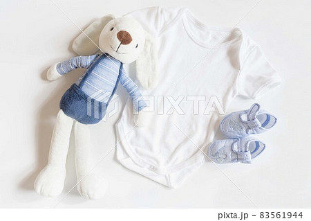 Newborn baby clothing and rabbit toy on white background,Top view, flat lay. Newborn baby clothing and rabbit toy on white background,Top view, flat lay. 83561944