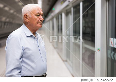 Senior man waiting in subway station Senior man waiting in subway station 83565572