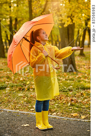 girl with an umbrella and rubber boots on an autumn walk 83566983