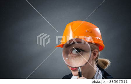 Technical inspector looking through magnifier Technical inspector looking through magnifier 83567511