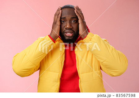Shocked upset african-american bearded guy feel regret stunned hear terrible news hold hands head widen eyes stupor standing speechless troubled, look perplexed terribly sad, pink background Shocked upset african-american bearded guy feel regret stunned hear terrible news hold hands head widen eyes stupor standing speechless troubled, look perplexed terribly sad, pink background 83567598