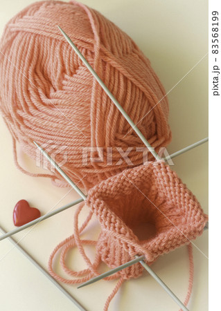 pink yarn ball and knitting needles pink yarn ball and knitting needles 83568199