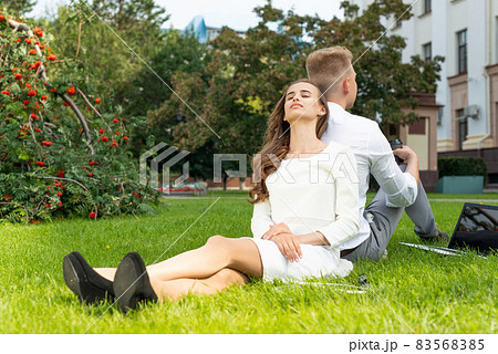 young woman in the park on the grass young woman in the park on the grass 83568385