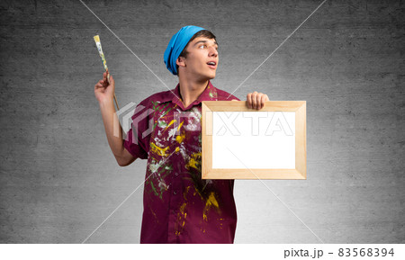 Young handsome painter artist holding paintbrush 83568394