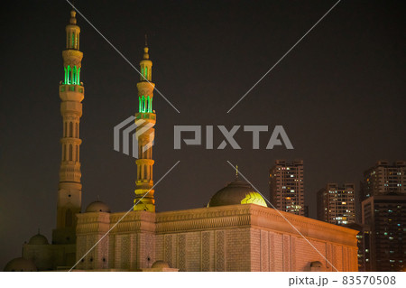 Night View Of Al Remeila Mosque, New Residential Multi-storey Houses In Ajman, United Arab Emirates Night View Of Al Remeila Mosque, New Residential Multi-storey Houses In Ajman, United Arab Emirates 83570508