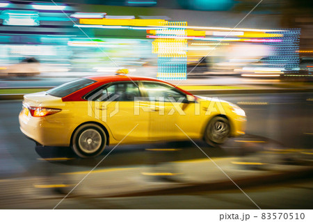 Speeding Taxi Car Fast Driving In City Street. Motion Blur Background 83570510