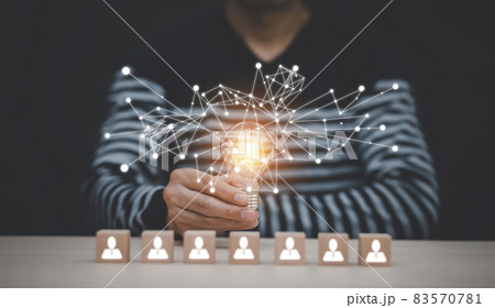 Man hand holding light bulb with Business icon on wood cube and working on desk, Creativity, and innovation are keys to success. Concept of new idea and innovation with Brain and light bulbs. Man hand holding light bulb with Business icon on wood cube and working on desk, Creativity, and innovation are keys to success. Concept of new idea and innovation with Brain and light bulbs. 83570781