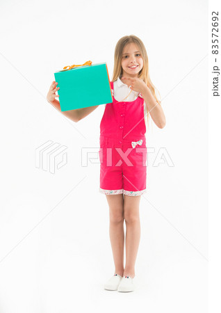 Little child point finger at shopping bag isolated on white. 83572692