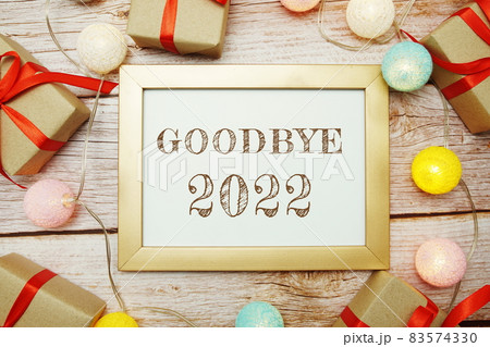 Goodbye 2022 typography text with LED cotton ball on wooden background Goodbye 2022 typography text with LED cotton ball on wooden background 83574330