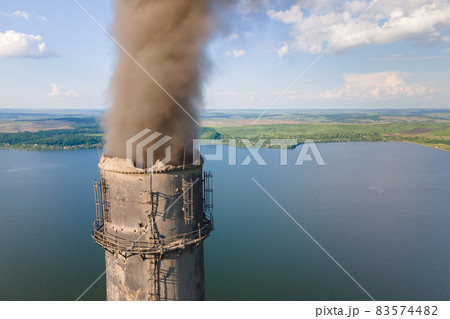 Aerial view of coal power plant high pipes with black smokestack polluting atmosphere. Electricity production with fossil fuel concept. Aerial view of coal power plant high pipes with black smokestack polluting atmosphere. Electricity production with fossil fuel concept. 83574482
