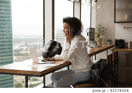 Busy happy young african american businesswoman multitasking in modern office. 83578308