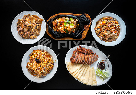 Group of different Asian dishes of baked Peking duck, Chow Mein noodles in iron pan, shrimp with vegetables. chicken stew almonds, carrots and pasta. Flat lay . Group of different Asian dishes of baked Peking duck, Chow Mein noodles in iron pan, shrimp with vegetables. chicken stew almonds, carrots and pasta. Flat lay . 83580066