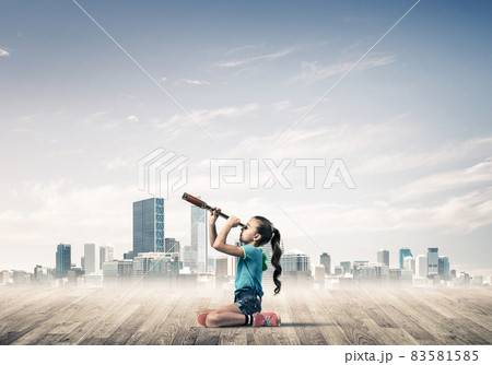 Concept of careless happy childhood with girl dreaming about future 83581585