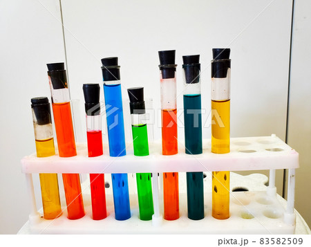 Laboratory tableware with colorful liquid. Multicolored liquid in a laboratory dish, close-up. 83582509