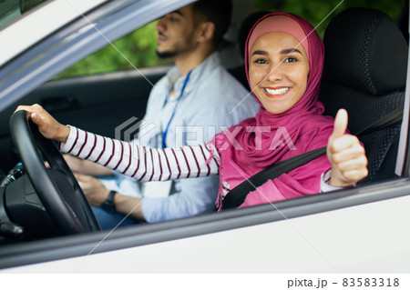 Happy Muslim Woman Showing Thumb Up After Successful Exam In Driving School 83583318