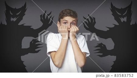 Inner Fears. Terrified Teen Boy Standing With Shadow Monsters Drawn Around Him Inner Fears. Terrified Teen Boy Standing With Shadow Monsters Drawn Around Him 83583752