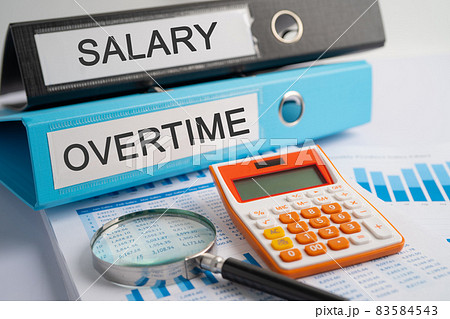 Salary, Overtime. Binder data finance report business with graph analysis in office. Salary, Overtime. Binder data finance report business with graph analysis in office. 83584543
