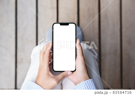 hand using mock-up phone mobile on top angle view 83584716
