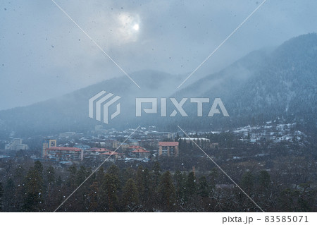 Winter mountain landscape. Small town between mountains. A cloud hangs over the city 83585071
