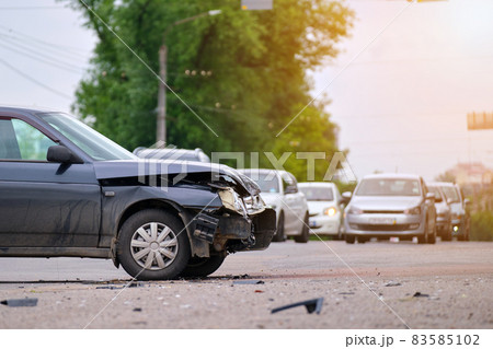 Damaged in car accident vehicle on city street crash site. 83585102