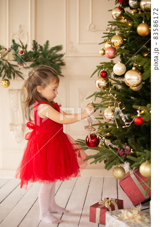 Little girl excited for christmas holidays with all these gifts and fairytale decoration Little girl excited for christmas holidays with all these gifts and fairytale decoration 83586172