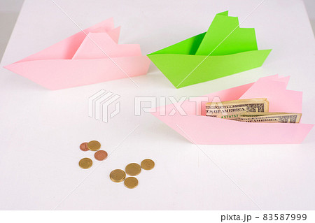 Business concept, 3-paper boats sailing forward and money on Board, a few coins ahead 83587999