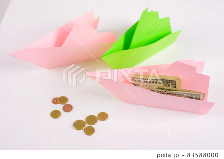 Business concept, 3-paper boats floating nearby and money on Board, a few coins ahead Business concept, 3-paper boats floating nearby and money on Board, a few coins ahead 83588000