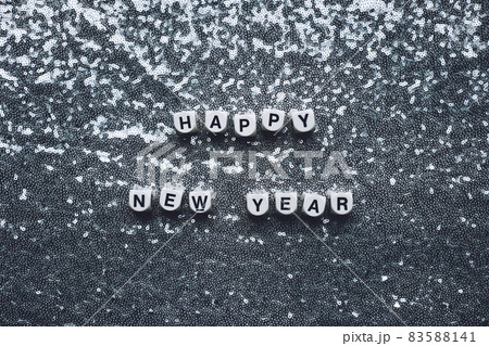 Happy new year text on silver sparkles sequin background. Trendy minimal modern Happy new year web banner, greeting card 83588141