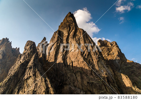 The Crimean Peninsula. July 21, 2021. A picturesque and mysterious view of high rocks on Cape Karagach near the city of Koktebel from the Black Sea. The Crimean Peninsula. July 21, 2021. A picturesque and mysterious view of high rocks on Cape Karagach near the city of Koktebel from the Black Sea. 83588180