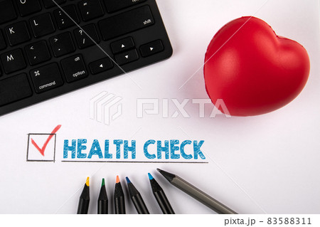 Health Check. Red rubber heart and black computer keyboard on a white background Health Check. Red rubber heart and black computer keyboard on a white background 83588311