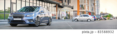Panoramic view of new shiny expensive car parked on city street side. 83588932