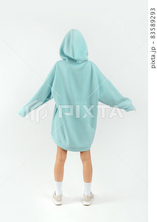 Young pretty woman wearing turquoise hoodie and gray cycling shorts on white background Young pretty woman wearing turquoise hoodie and gray cycling shorts on white background 83589293