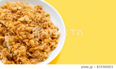Dried shredded pork in white plate on yellow background. 83590003