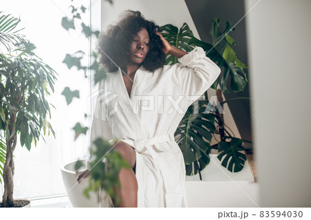 Cute young woman in a white bathrobe relaxing Cute young woman in a white bathrobe relaxing 83594030