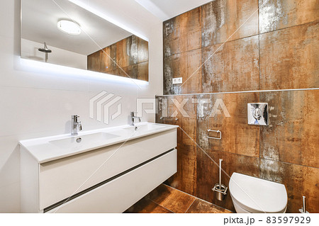 Bathroom with big mirror and two faucets Bathroom with big mirror and two faucets 83597929