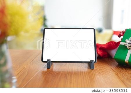 Tablet with copy space on screen lying on table with christmas decorations 83598551