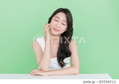 beauty concept, beautiful Korean Asian woman resting chin on hand beauty concept, beautiful Korean Asian woman resting chin on hand 83599511