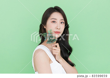 beauty concept, beautiful Korean Asian woman with green leaf beauty concept, beautiful Korean Asian woman with green leaf 83599659
