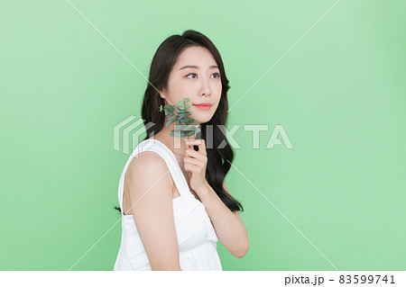 beauty concept, beautiful Korean Asian woman with green leaf beauty concept, beautiful Korean Asian woman with green leaf 83599741