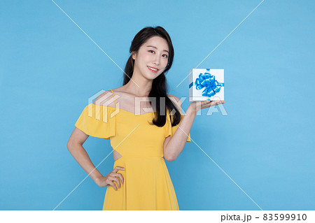 shopping event concept, beautiful Korean Asian woman in yellow summer holding gift boxdelivery box shopping event concept, beautiful Korean Asian woman in yellow summer holding gift boxdelivery box 83599910