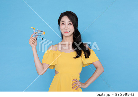 beautiful Korean Asian model with cart miniature, summer shopping event concept beautiful Korean Asian model with cart miniature, summer shopping event concept 83599943