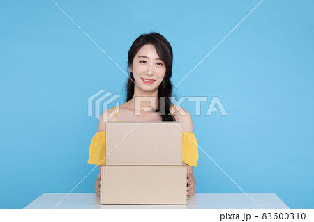 shopping event concept, surprised Korean Asian woman showing delivery box shopping event concept, surprised Korean Asian woman showing delivery box 83600310