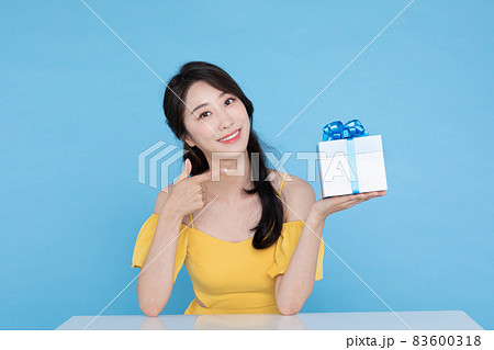 shopping event concept, beautiful Korean Asian woman pointing at gift box shopping event concept, beautiful Korean Asian woman pointing at gift box 83600318
