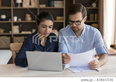 Concentrated mixed race employees working on online project. Concentrated mixed race employees working on online project. 83601536
