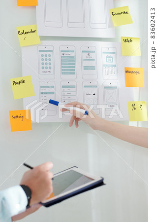 Business People Discussing Interface Mockups Business People Discussing Interface Mockups 83602413